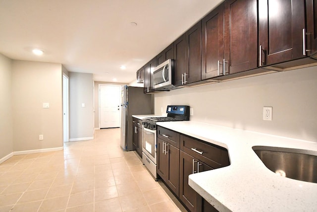 86 Lander St, Newburgh, NY 12550 - kitchen featuring stainless steel appliances, light countertops, dark brown cabinets, baseboards, and recessed lighting