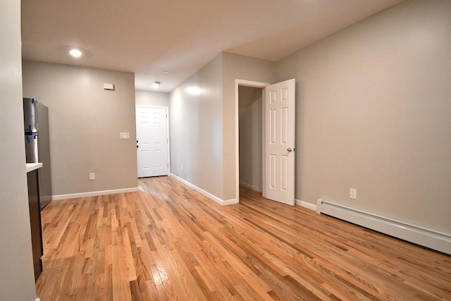 86 Lander St, Newburgh, NY 12550 - empty room featuring light wood finished floors, baseboards, a baseboard heating unit, and recessed lighting