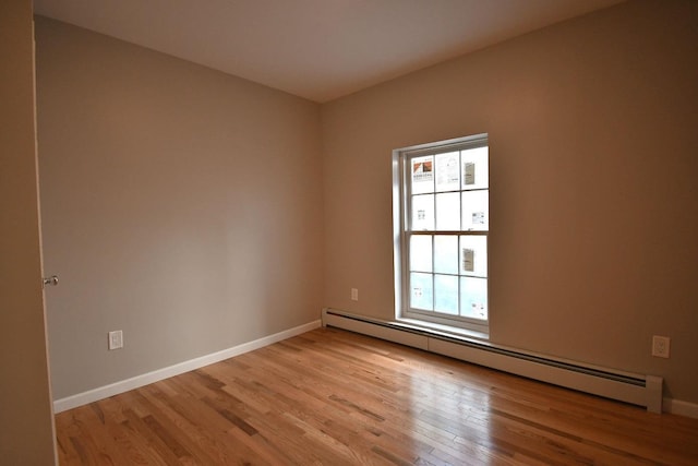 86 Lander St, Newburgh, NY 12550 - empty room featuring baseboard heating, light wood-type flooring, and baseboards