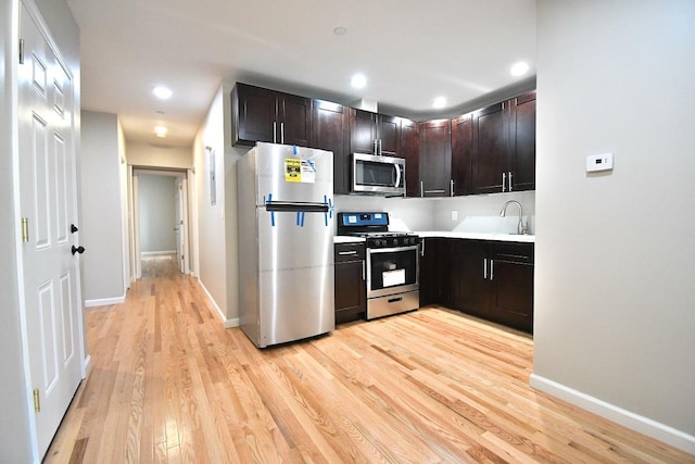 86 Lander St, Newburgh, NY 12550 - kitchen with appliances with stainless steel finishes, light wood-style floors, light countertops, baseboards, and recessed lighting