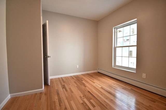 86 Lander St, Newburgh, NY 12550 - empty room with a baseboard radiator, light wood-style floors, and baseboards