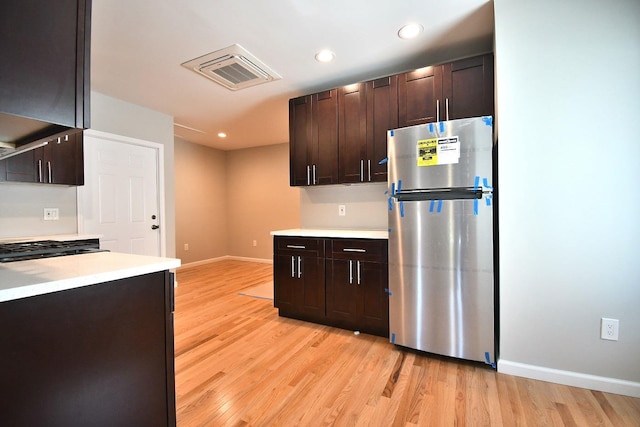 86 Lander St, Newburgh, NY 12550 - kitchen with freestanding refrigerator, light wood finished floors, dark brown cabinetry, and recessed lighting