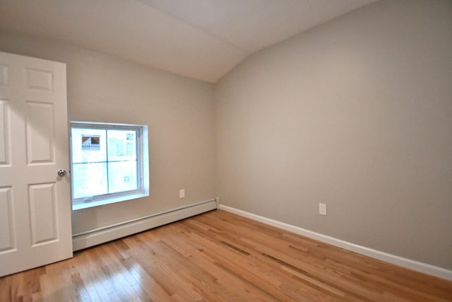 86 Lander St, Newburgh, NY 12550 - spare room with a baseboard radiator, light wood-style flooring, baseboards, and vaulted ceiling