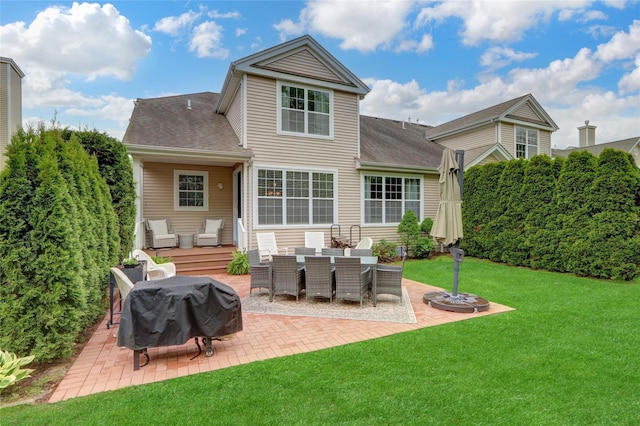 30 Toni Ct Unit 30, Center Moriches, NY 11934 - back of property featuring a patio, a lawn, a deck, and a shingled roof