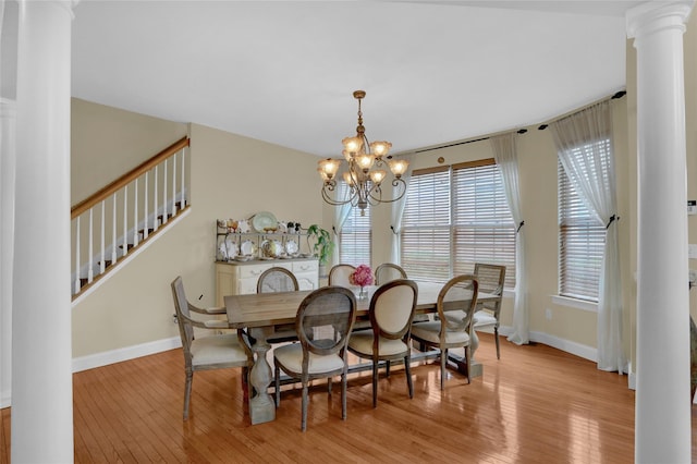 30 Toni Ct Unit 30, Center Moriches, NY 11934 - dining space with decorative columns, light wood-style floors, a chandelier, and baseboards