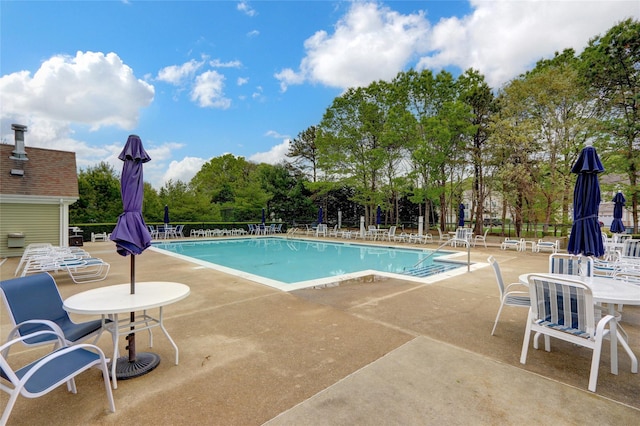 30 Toni Ct Unit 30, Center Moriches, NY 11934 - community pool featuring a patio and view of scattered trees