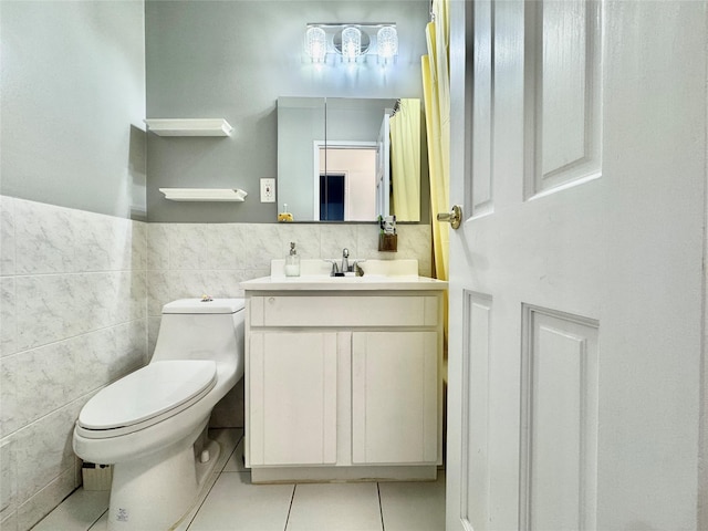 20426 45th Dr, Bayside, NY 11361 - full bathroom featuring tile patterned flooring, vanity, toilet, tile walls, and a wainscoted wall