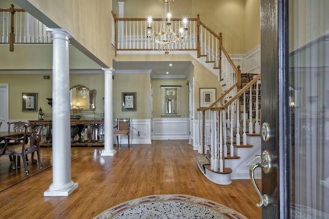 21 Hathaway Ln, Manhasset, NY 11030 - foyer with a high ceiling, decorative columns, stairway, wood finished floors, and ornamental molding