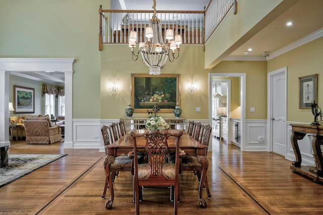 21 Hathaway Ln, Manhasset, NY 11030 - dining area with a chandelier, wood finished floors, crown molding, a wainscoted wall, and a high ceiling