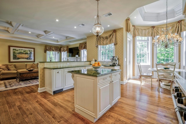 21 Hathaway Ln, Manhasset, NY 11030 - kitchen with a chandelier, ornamental molding, a kitchen island, open floor plan, and light wood-type flooring
