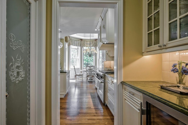 21 Hathaway Ln, Manhasset, NY 11030 - kitchen featuring range with two ovens, wine cooler, dark wood-style floors, tasteful backsplash, and glass insert cabinets