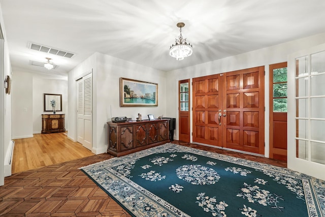 3 David Rd, Somers, NY 10589 - foyer featuring a chandelier, parquet flooring, and a baseboard radiator