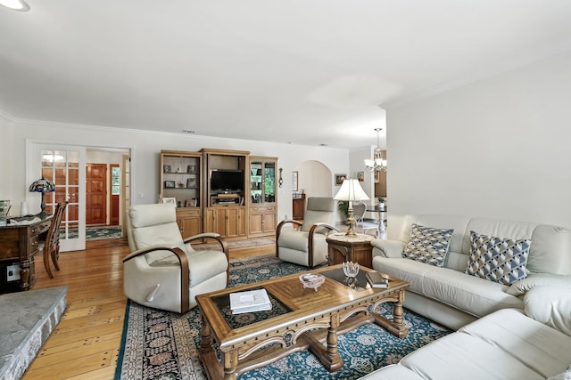 3 David Rd, Somers, NY 10589 - living room with ornamental molding, a chandelier, and light wood-type flooring
