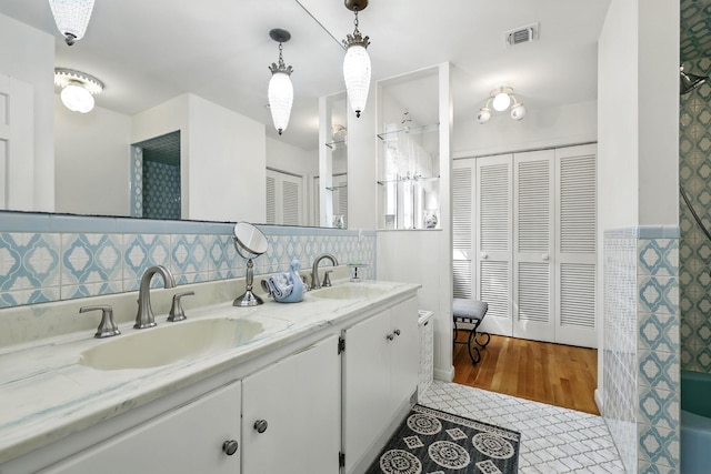 3 David Rd, Somers, NY 10589 - full bathroom featuring a closet, double vanity, tile walls, and tile patterned floors