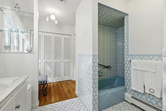 3 David Rd, Somers, NY 10589 - bathroom with a baseboard heating unit, a closet, vanity, wainscoting, and tub / shower combination