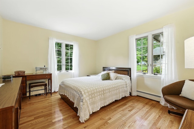 3 David Rd, Somers, NY 10589 - bedroom with baseboard heating, multiple windows, and light wood-style floors