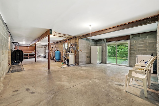 3 David Rd, Somers, NY 10589 - basement with freestanding refrigerator, oil tank, a heating unit, concrete block wall, and a water pressure tank