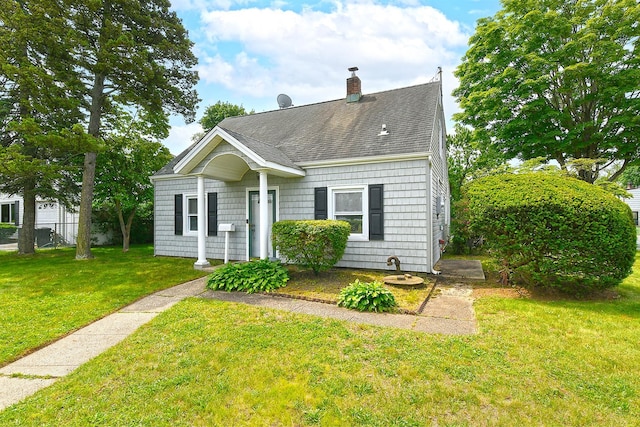 2 Anvil Ln, Levittown, NY 11756 - view of front of home featuring roof with shingles, a front yard, and a chimney