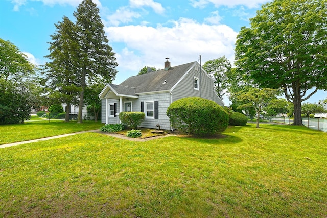 2 Anvil Ln, Levittown, NY 11756 - view of front of home featuring a front yard, a chimney, and roof with shingles