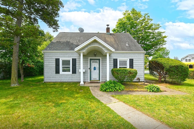 2 Anvil Ln, Levittown, NY 11756 - view of front of house with a chimney, a front yard, and a shingled roof