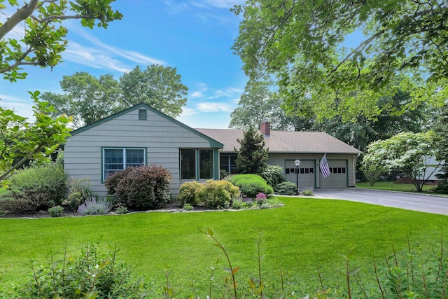 43 Sound Rd, Greenport, NY 11944 - ranch-style house featuring concrete driveway, an attached garage, a front yard, and a chimney