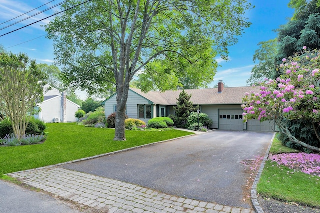 43 Sound Rd, Greenport, NY 11944 - ranch-style house featuring asphalt driveway, a garage, a front yard, and a chimney