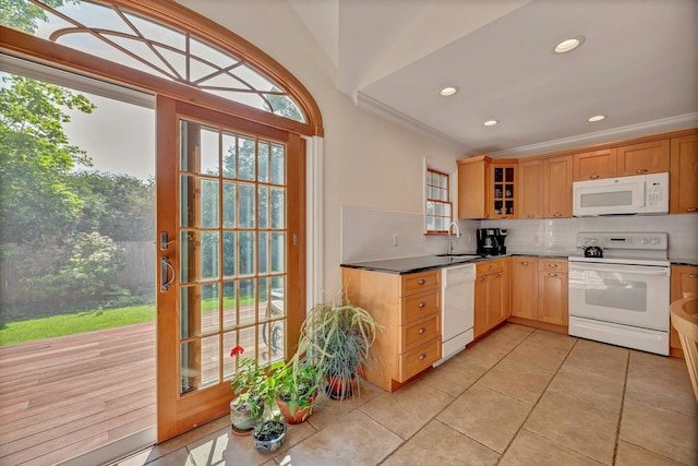 43 Sound Rd, Greenport, NY 11944 - kitchen featuring white appliances, decorative backsplash, light tile patterned flooring, ornamental molding, and glass insert cabinets