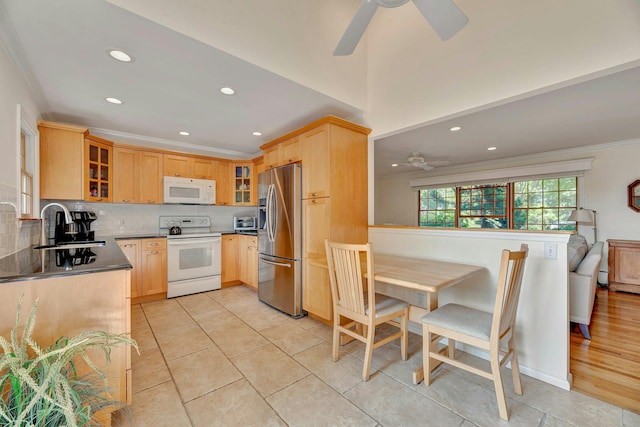 43 Sound Rd, Greenport, NY 11944 - kitchen with white appliances, a ceiling fan, glass insert cabinets, recessed lighting, and crown molding
