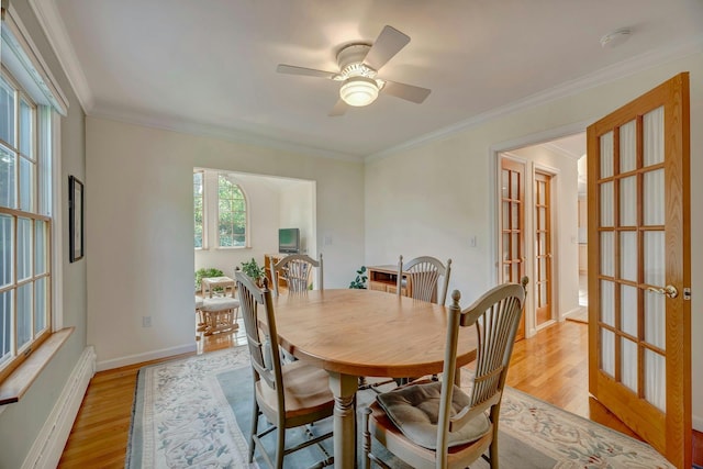 43 Sound Rd, Greenport, NY 11944 - dining area with french doors, light wood-style floors, ceiling fan, a baseboard heating unit, and crown molding