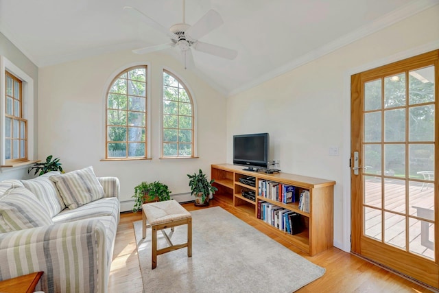 43 Sound Rd, Greenport, NY 11944 - living room with healthy amount of natural light, vaulted ceiling, light wood finished floors, a ceiling fan, and ornamental molding