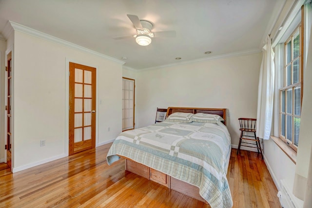 43 Sound Rd, Greenport, NY 11944 - bedroom with a baseboard heating unit, light wood-style flooring, crown molding, and ceiling fan