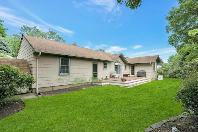 43 Sound Rd, Greenport, NY 11944 - rear view of house featuring a deck, a lawn, roof with shingles, and a chimney