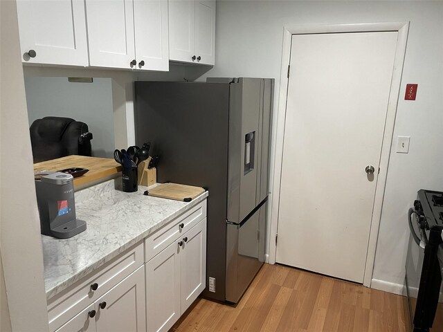 340 Concord Ln, Middletown, NY 10940 - kitchen featuring light wood-style flooring, stainless steel fridge, black gas stove, and white cabinets