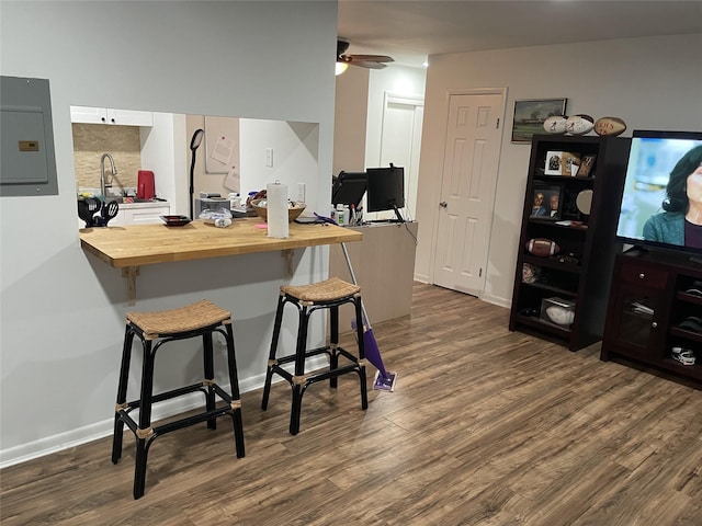 340 Concord Ln, Middletown, NY 10940 - kitchen with wooden counters, electric panel, dark wood finished floors, and a kitchen breakfast bar