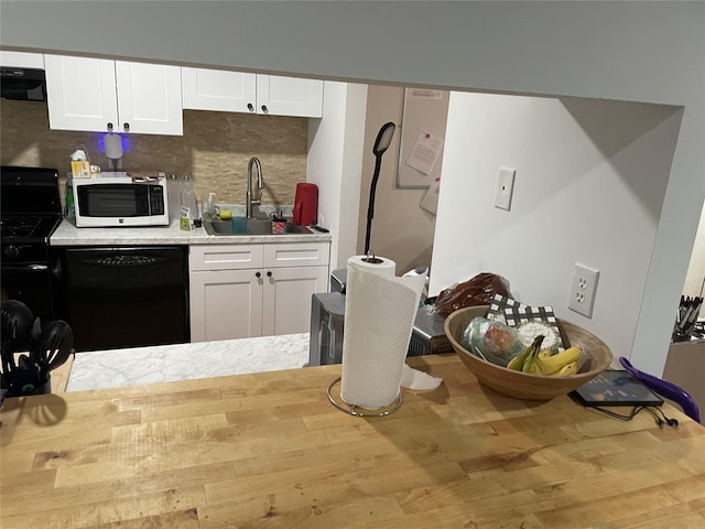 340 Concord Ln, Middletown, NY 10940 - kitchen featuring black dishwasher, white microwave, extractor fan, light countertops, and backsplash