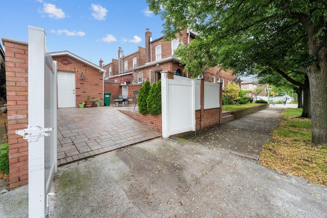 11401 115th St, South Ozone Park, NY 11420 - view of side of property with brick siding and a patio area