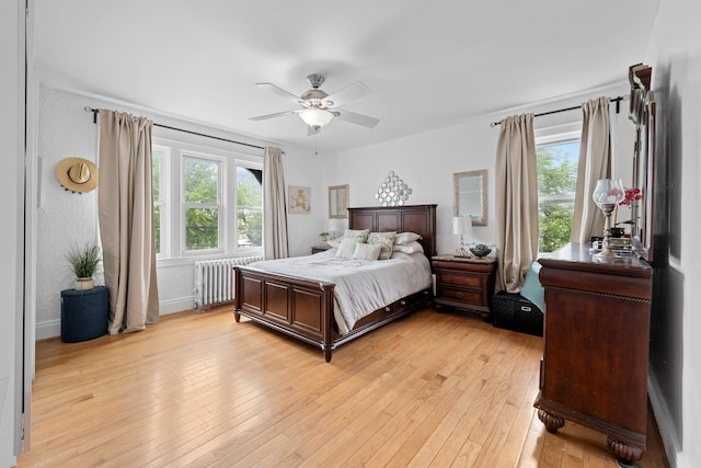 11401 115th St, South Ozone Park, NY 11420 - bedroom featuring radiator heating unit, light wood finished floors, and a ceiling fan