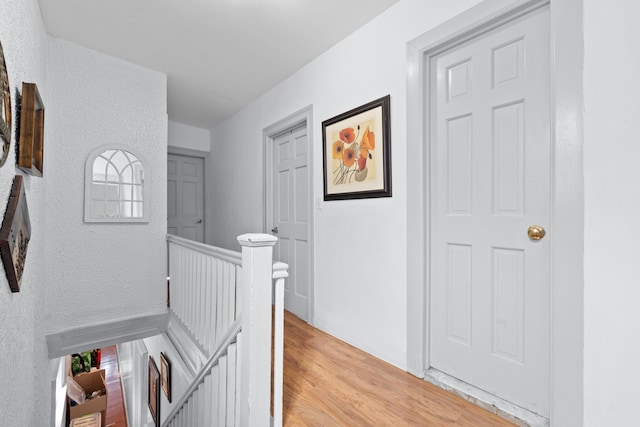 11401 115th St, South Ozone Park, NY 11420 - hall with an upstairs landing, light wood-style floors, and a textured wall