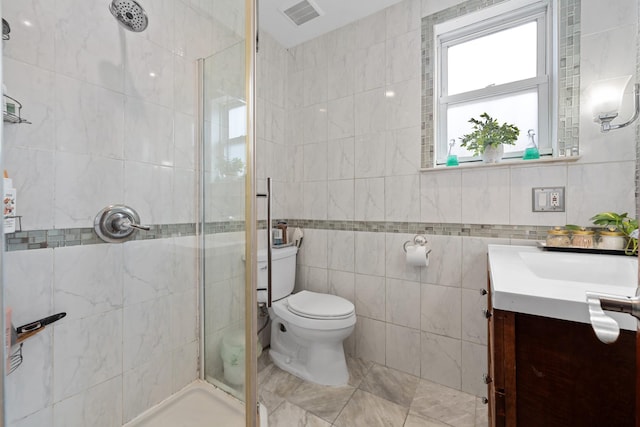 11401 115th St, South Ozone Park, NY 11420 - full bathroom with vanity, a shower stall, tile walls, and toilet