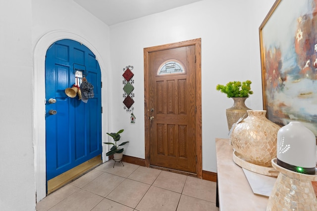 11401 115th St, South Ozone Park, NY 11420 - foyer entrance with light tile patterned flooring, arched walkways, and baseboards