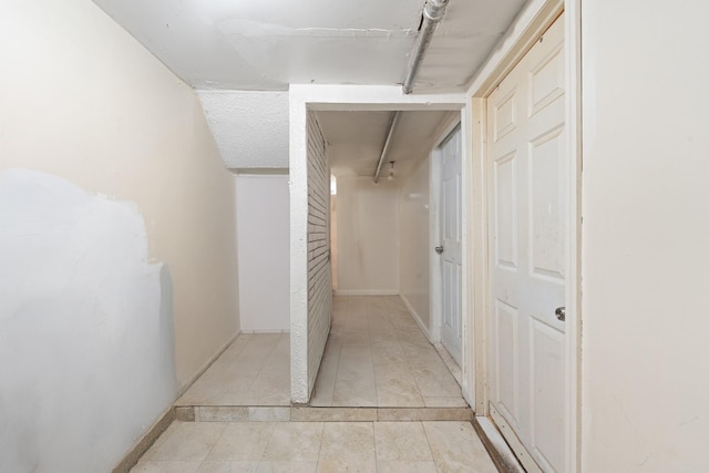 11401 115th St, South Ozone Park, NY 11420 - hallway featuring light tile patterned floors and baseboards