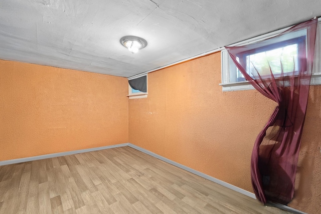 11401 115th St, South Ozone Park, NY 11420 - basement featuring a textured wall, wood finished floors, and baseboards