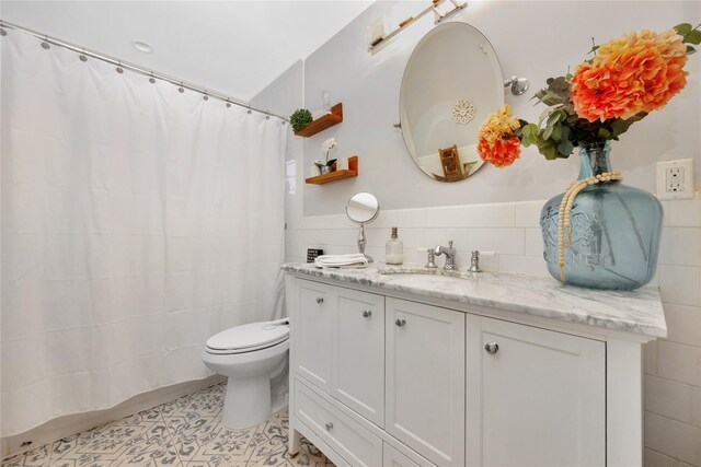 1582 Little Neck Ave, North Bellmore, NY 11710 - full bathroom with tile walls, vanity, toilet, tile patterned floors, and a shower with curtain