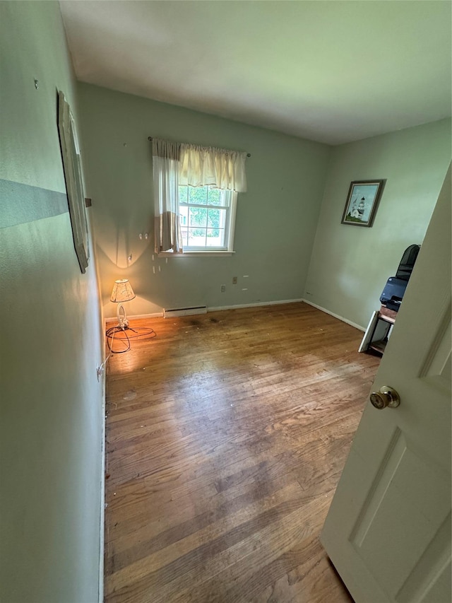 8 Hom St, Chester, NY 10918 - unfurnished room featuring a baseboard heating unit, wood finished floors, and baseboards