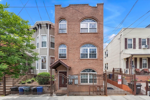 90 Milford St, Brooklyn, NY 11208 - view of front of home with brick siding, a gate, a fenced front yard, and cooling unit