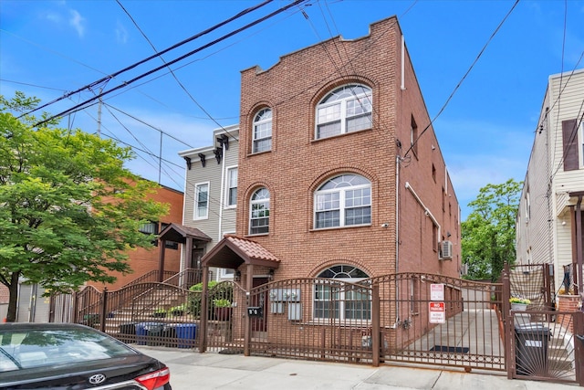 90 Milford St, Brooklyn, NY 11208 - view of front of property featuring a gate, brick siding, and a fenced front yard