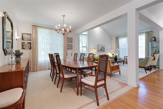 144 Burr Farms Rd, Mount Kisco, NY 10549 - dining area featuring a chandelier, light wood-style flooring, and vaulted ceiling