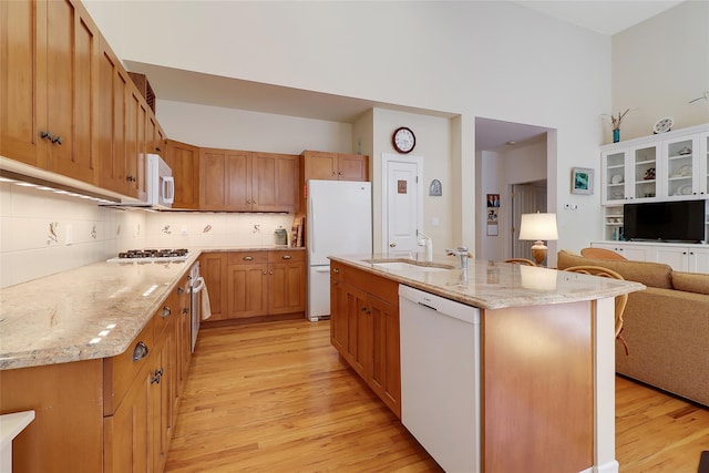 144 Burr Farms Rd, Mount Kisco, NY 10549 - kitchen with white appliances, light wood-type flooring, a sink, open floor plan, and decorative backsplash