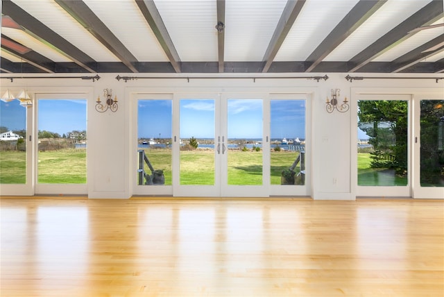 150 Senix Ave, Center Moriches, NY 11934 - unfurnished sunroom featuring beamed ceiling, french doors, and a water view