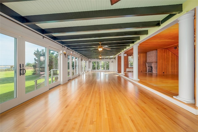 150 Senix Ave, Center Moriches, NY 11934 - unfurnished living room with ornate columns, beamed ceiling, ceiling fan, and wood finished floors